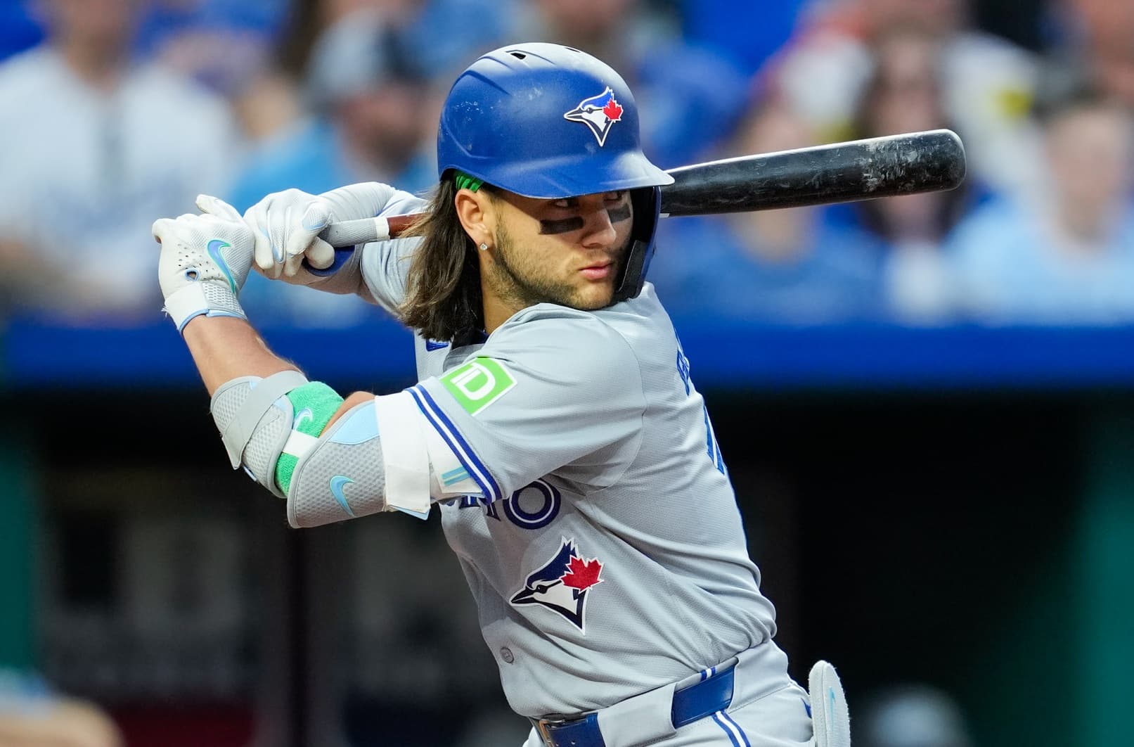 Toronto Blue Jays shortstop Bo Bichette (11) bats during the fifth inning against the Kansas City Royals at Kauffman Stadium.