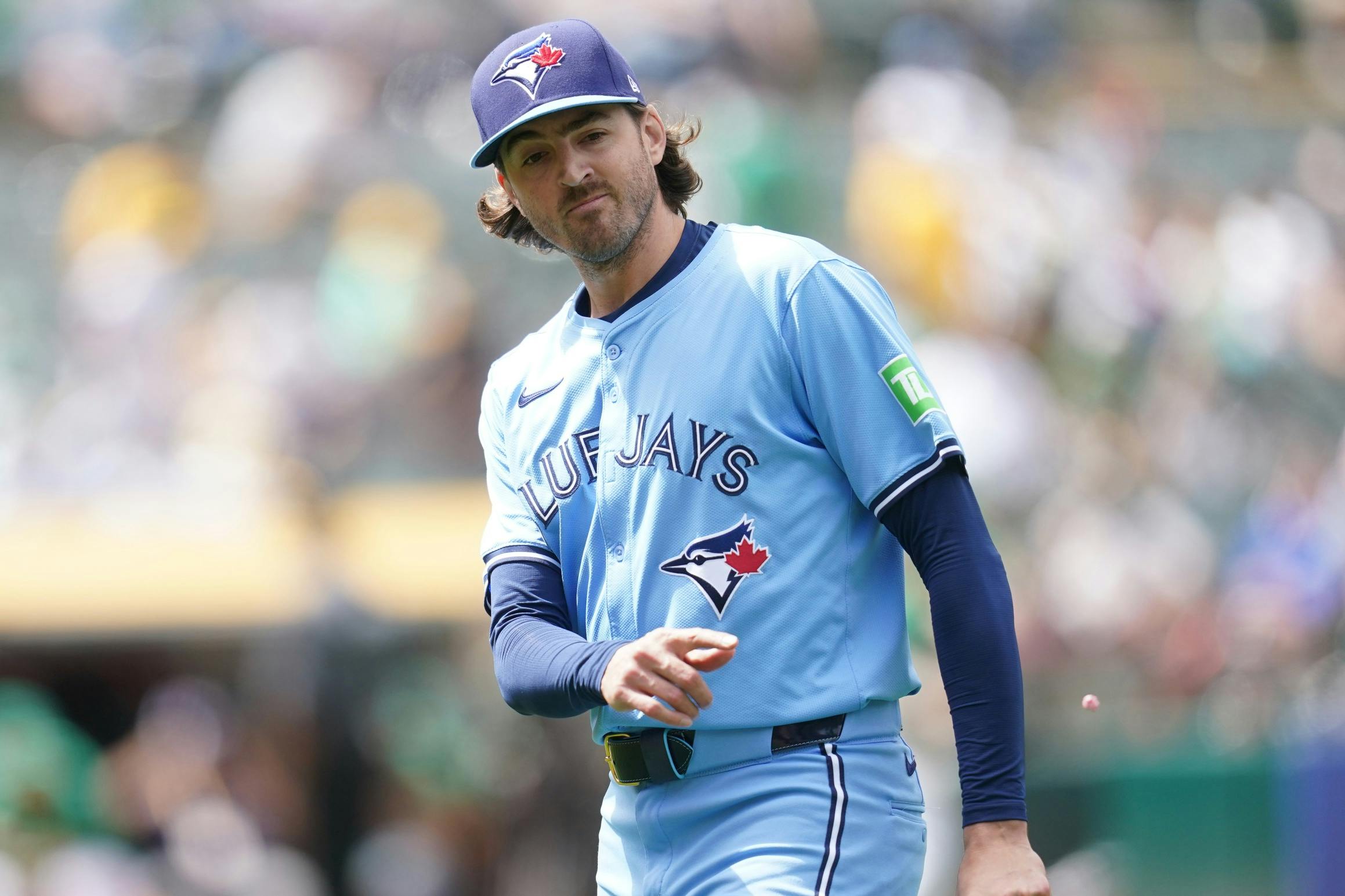 Toronto Blue Jays pitcher Kevin Gausman (34) tosses his gum at the end of the eighth inning against the Oakland Athletics at Oakland-Alameda County Coliseum.