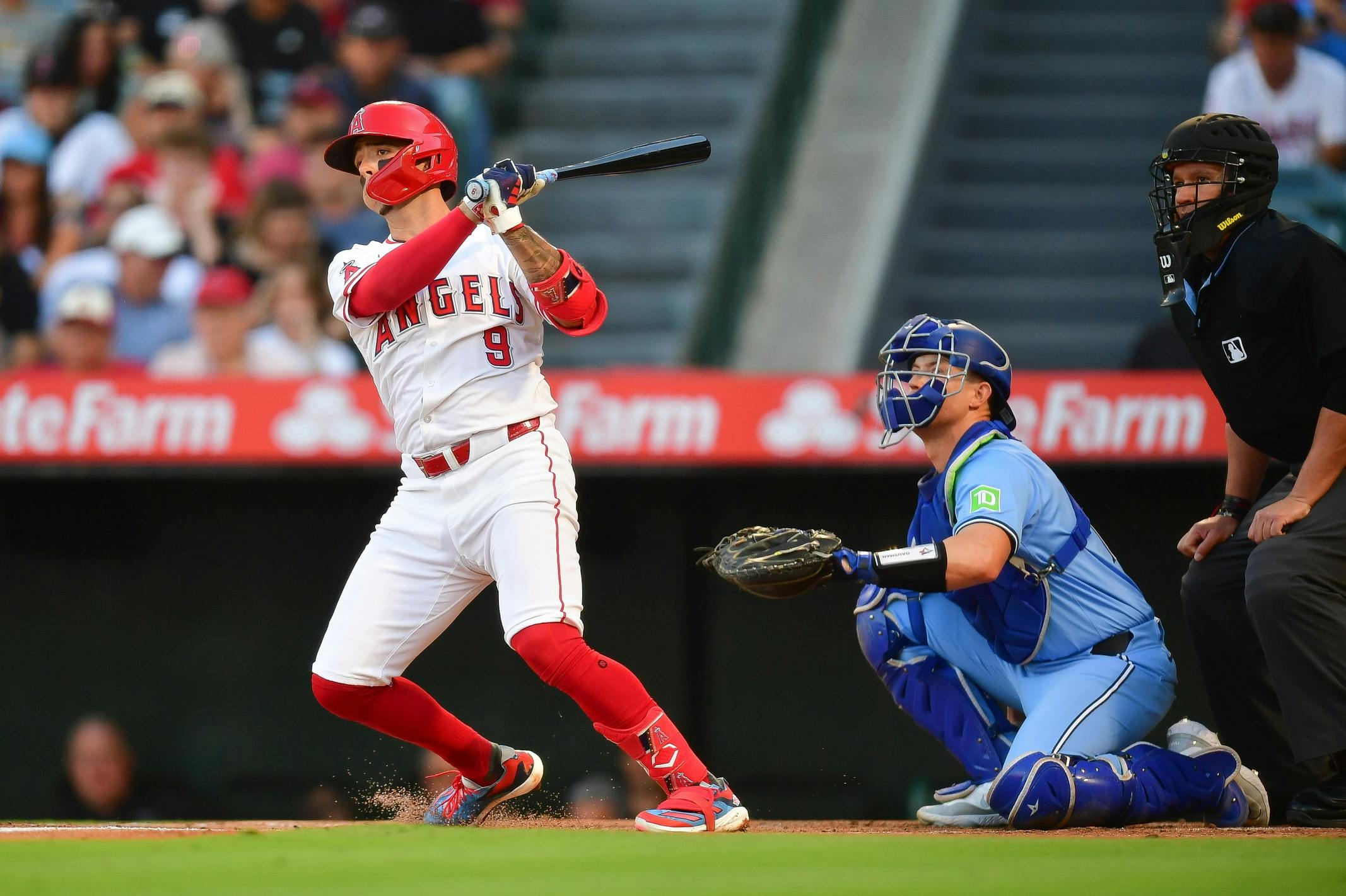 Los Angeles Angels shortstop Zach Neto (9) hits a single against the Toronto Blue Jays during the first inning at Angel Stadium.